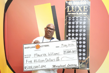 man holding a big check