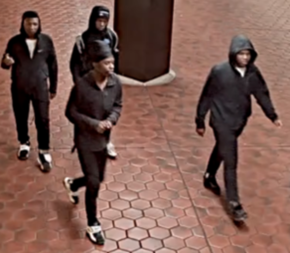 young men walking in group in metro station