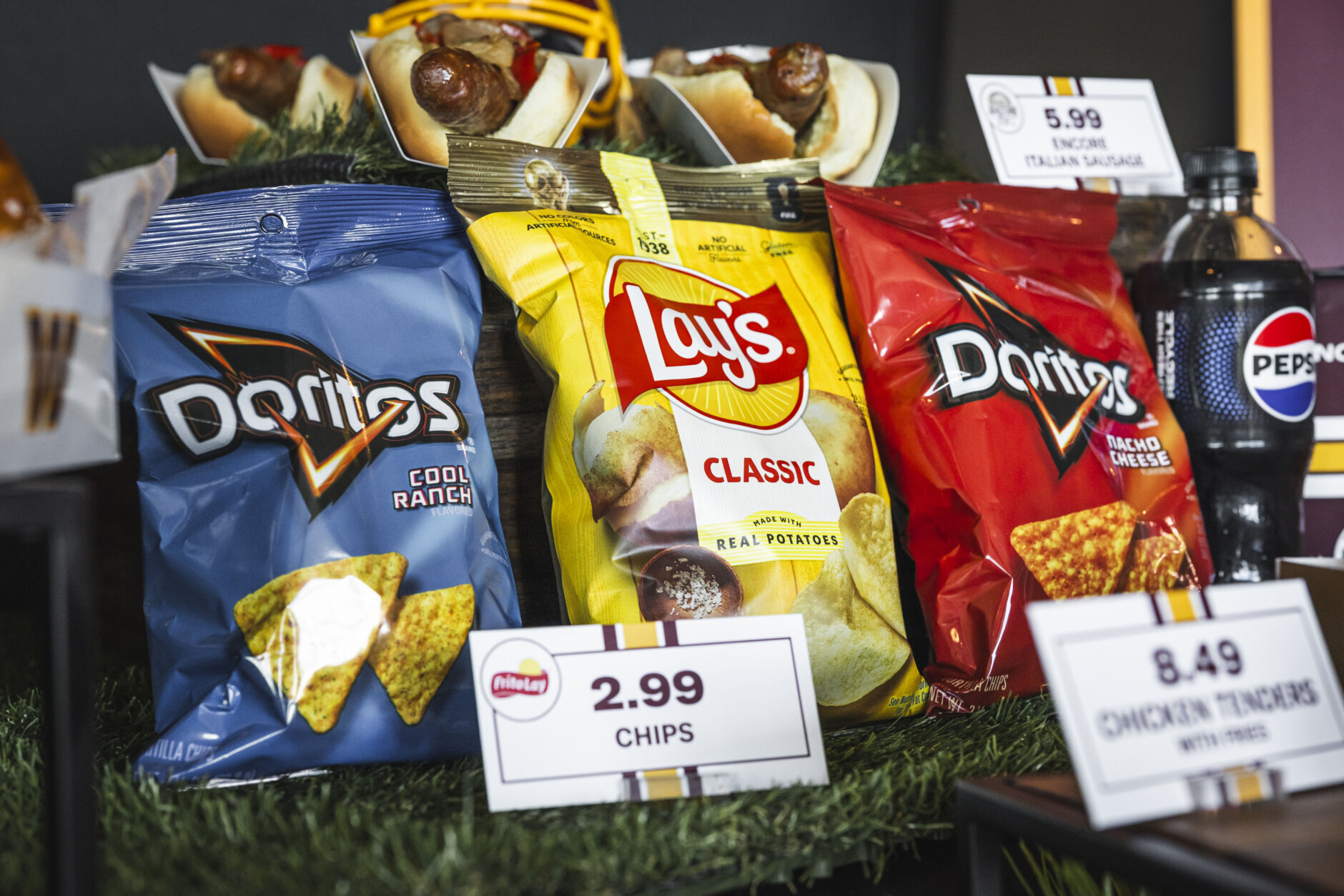 Bags of chips — Doritos on either side, lays in the middle — at a Washington Commanders press conference