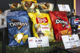 Bags of chips — Doritos on either side, lays in the middle — at a Washington Commanders press conference