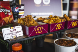 Cartons of wings and dipping-containers of sauce sit at a Washington Commanders' press conference.