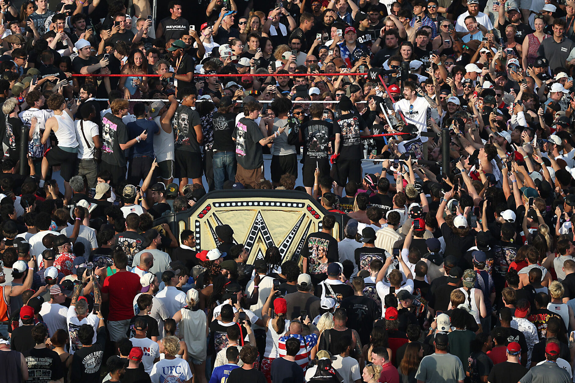 MMA fighter Sean Strickland gestures inside a fight cage before being escorted out of the UFC Freedom 250 Fan Fest on The Ellipse by U.S. Secret Service and other law enforcement ahead of the UFC Freedom 250 fight on the South Lawn of the White House on Sunday, June 14, 2026, in Washington. (Kevin Dietsch/Pool Photo via AP)