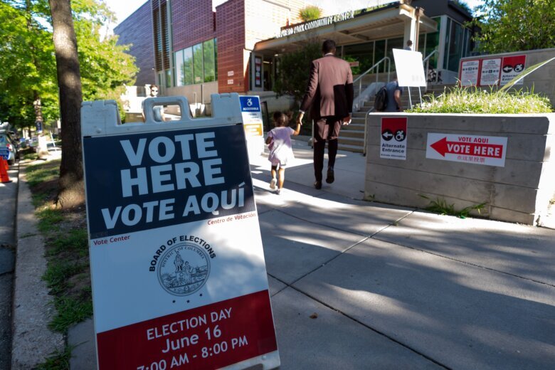 People arrive to their polling station during the D.C., primary election at Shepard Park Elementary, Tuesday, June 16, 2026, in Washington. (AP Photo/Jose Luis Magana)