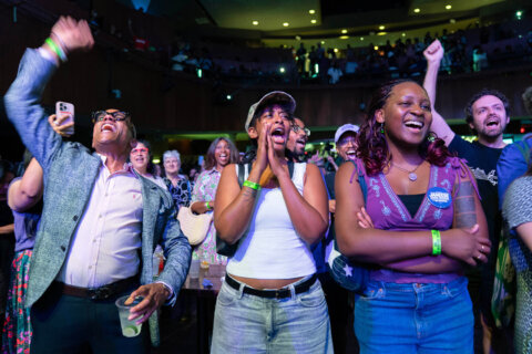 Supporters celebrate after D.C. Council member Janeese Lewis George won the D.C. Mayor primary election during an election night party at the Howard Theatre, Tuesday, June 16, 2026, in Washington. (AP Photo/Jose Luis Magana)