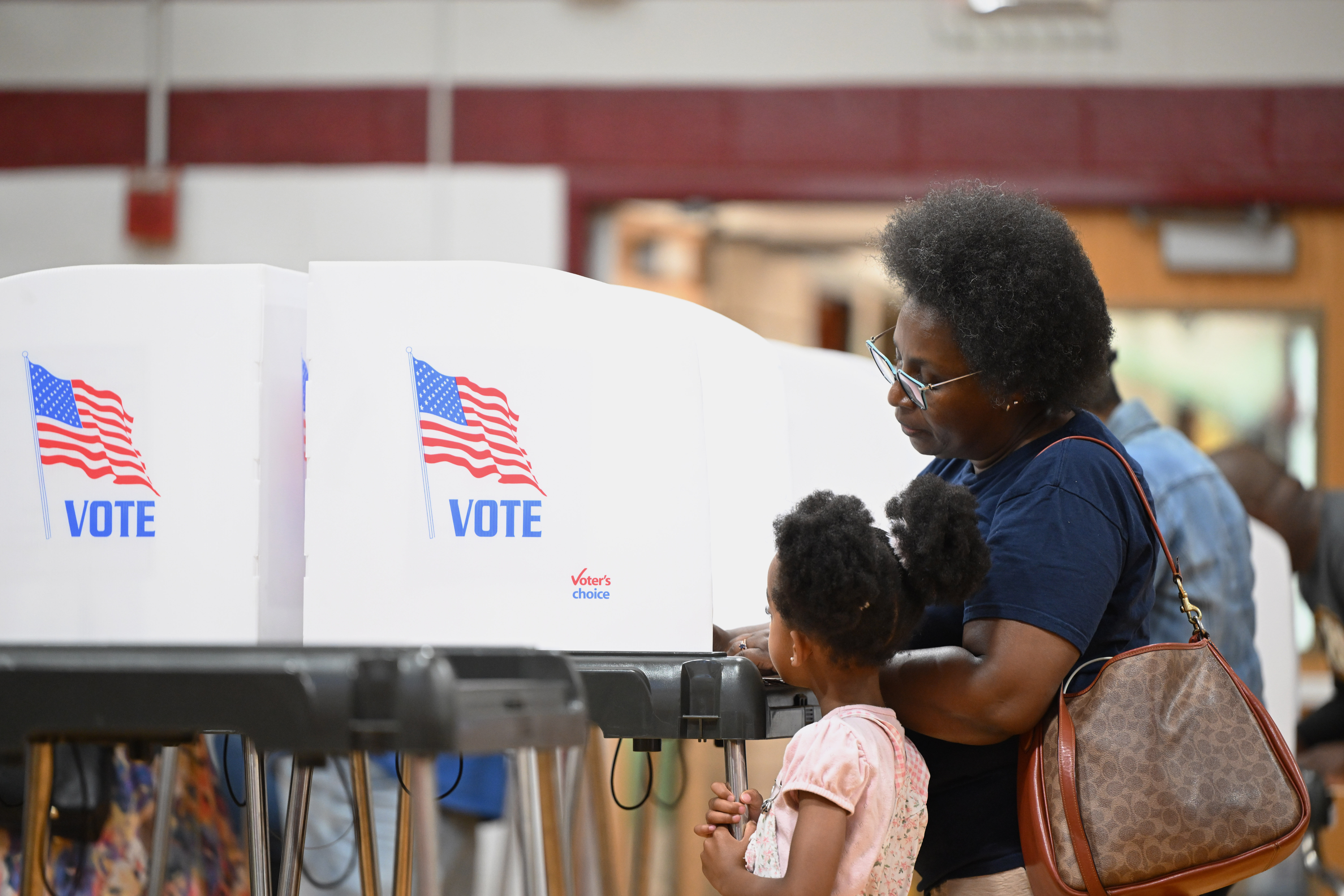 woman and child at voting booth