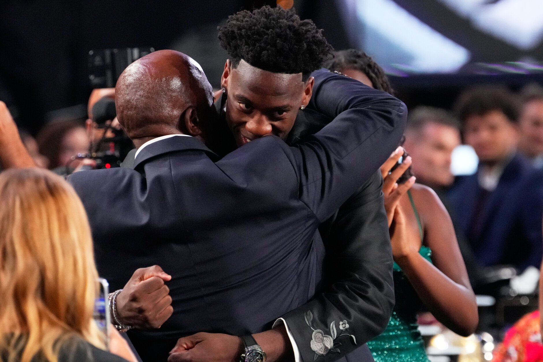 AJ Dybantsa, right, celebrates after being chosen by the Washington Wizards as the first pick in the first round of the NBA basketball draft, Tuesday, June 23, 2026, in New York. (AP Photo/Yuki Iwamura)