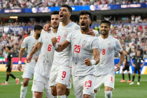 Iran opens its politically charged World Cup by playing to a 2-2 draw with New Zealand