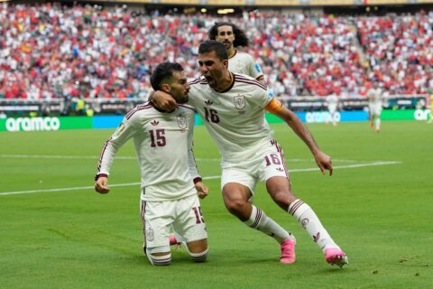 Spain wins its World Cup group, beating Uruguay 1-0 as Muslera’s error sends 2-time champion home