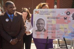 Eric Carpenter-Grantham looks at a Maryland driver’s license replica with the butterfly symbol