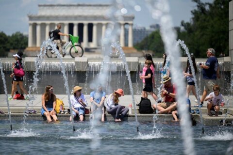 People put their feet in the water to cool off