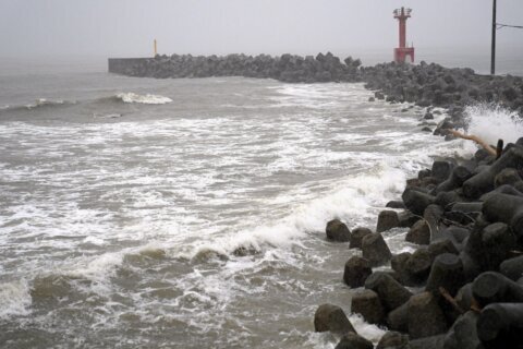 Heavy rain pounds western Japan as 2 tropical storms approach
