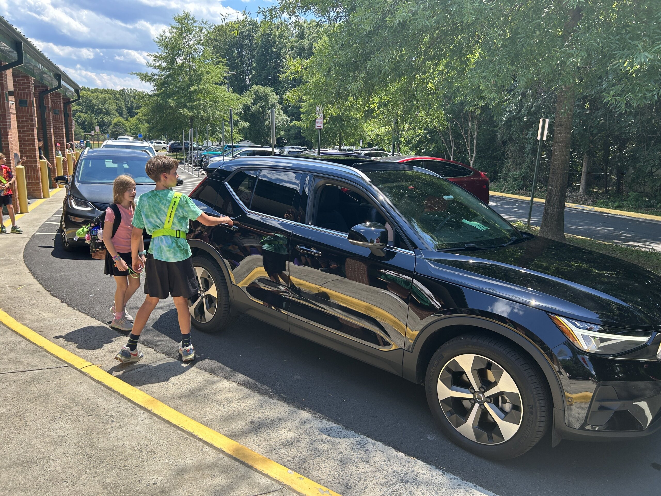 William Kinne escorting a student to her parents' car