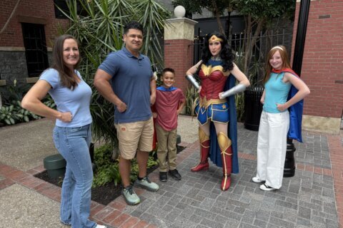Wonder woman poses with guests at Gaylord National