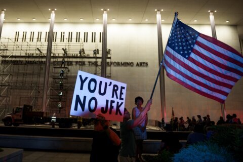 Trump’s name is still on the Kennedy Center, though officials say it will be down by noon