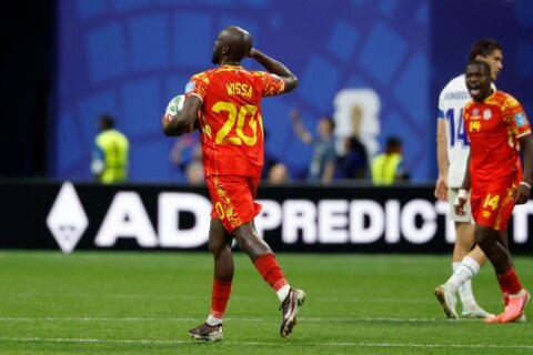 Congo rallies to a 3-1 win against Uzbekistan to seal place in the World Cup knockouts