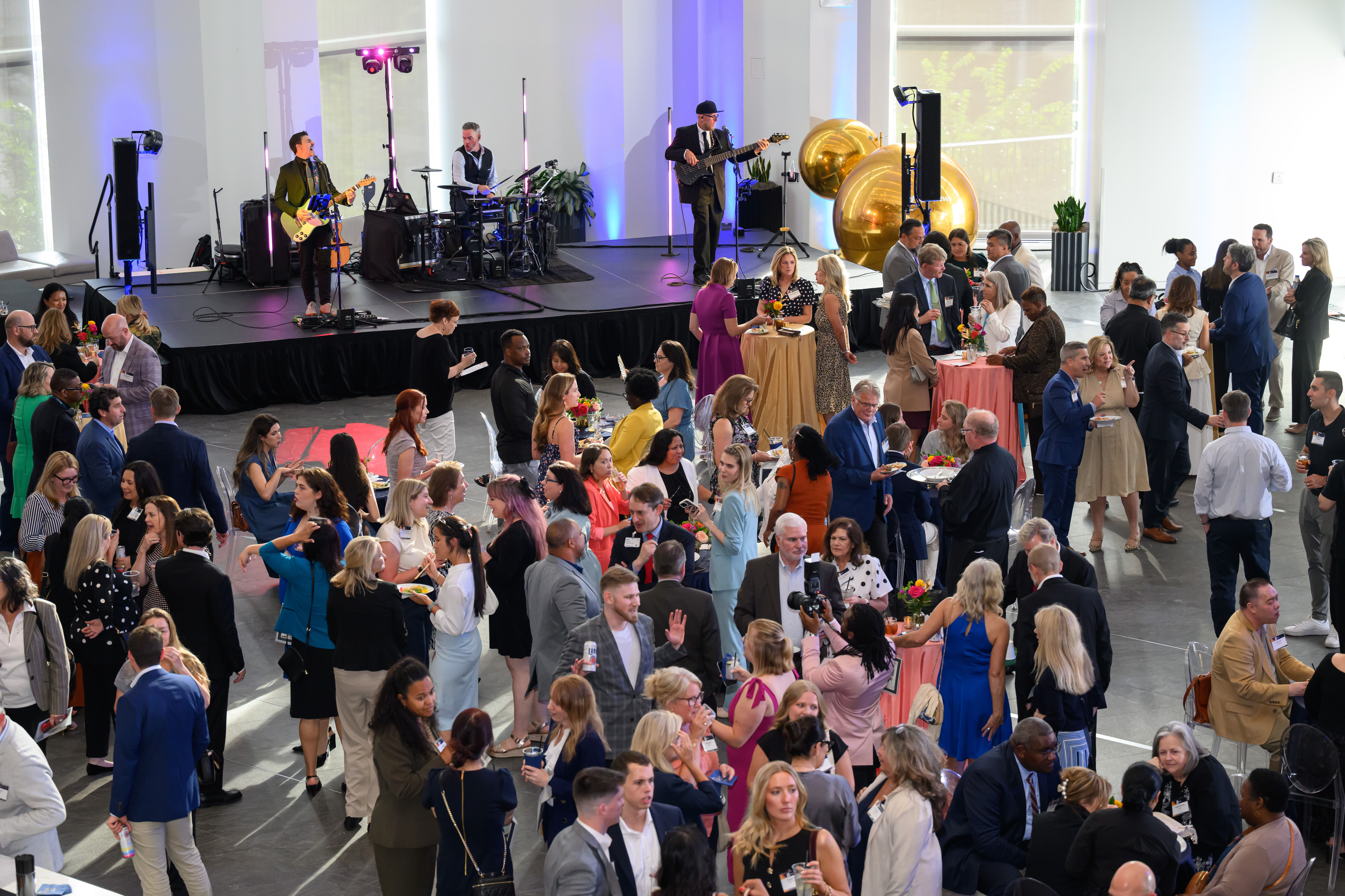 crowd of people while a band plays on a platform