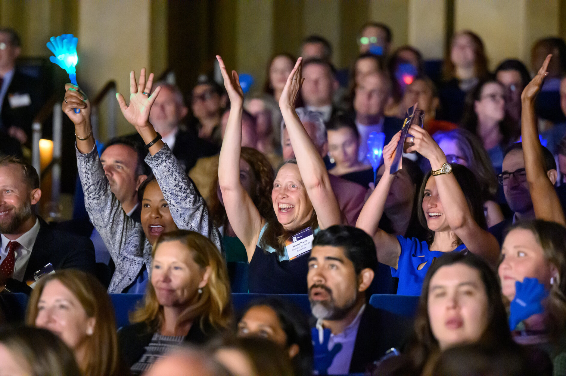 group of people cheering in a crowd