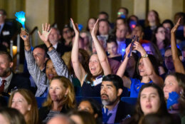 group of people cheering in a crowd