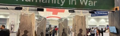 banner reading 'humanity in war' in large room