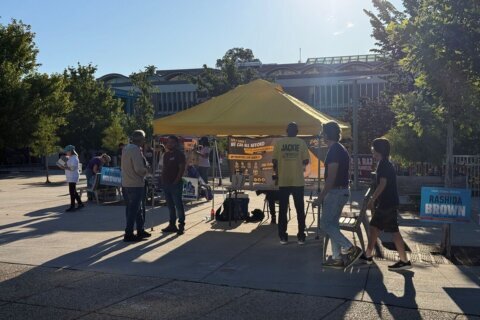 People standing around a table.