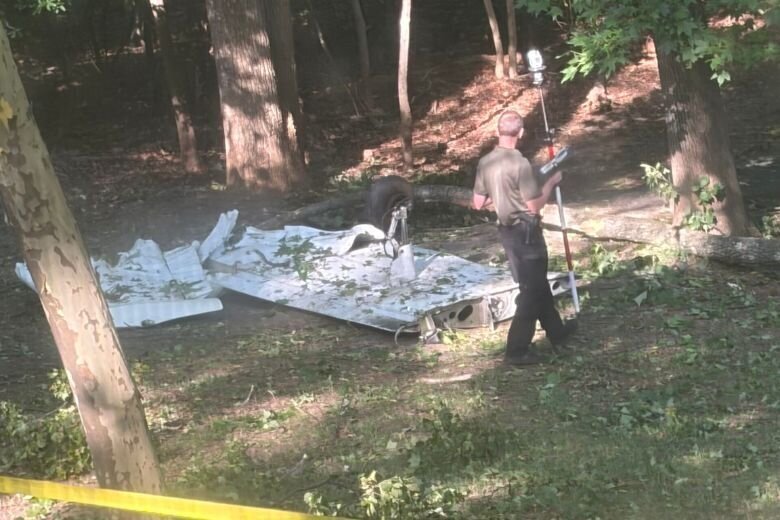 An investigator walks around the wing of a plane which crashed in Bowie on June 20, 2026.