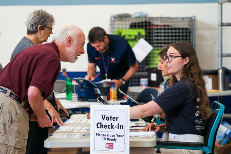 Voters check in at Lyles-Crouch Traditional Academy for the Virginia primary election, Tuesday, Aug. 4, 2026, in Alexandria, Va. (AP Photo/Allison Robbert)
