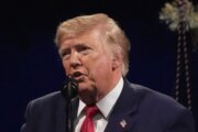 Trump posts a doctored photo of the Obamas and Air Force One with  graffiti spray-painted on plane