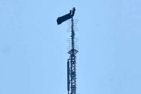 2 people hang banner about ‘the power of love’ on Empire State Building antenna