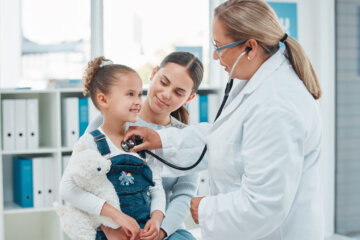 Shot of a doctor examining a little girl with a stethoscope in a clinic