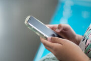 Close-up view of a little girl's hand using a smartphone