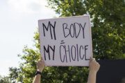 Woman holding "My Body, My Choice" sign