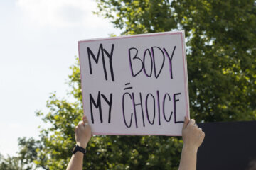 Woman holding "My Body, My Choice" sign