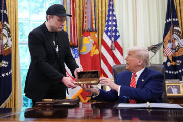 Elon Musk receives a key from President Donald Trump in the Oval Office