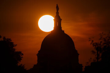 Sun sets behind US Capitol