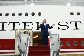 U.S. President Donald Trump steps out of the new Air Force One, gifted to him by by Qatar, in a hangar at Joint Base Andrews in Maryland on June 19, 2026. (Photo by Brendan SMIALOWSKI / AFP via Getty Images)