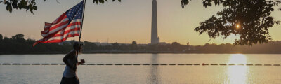 Pete Folch carries an American flag during a morning run along the Tidal Basin
