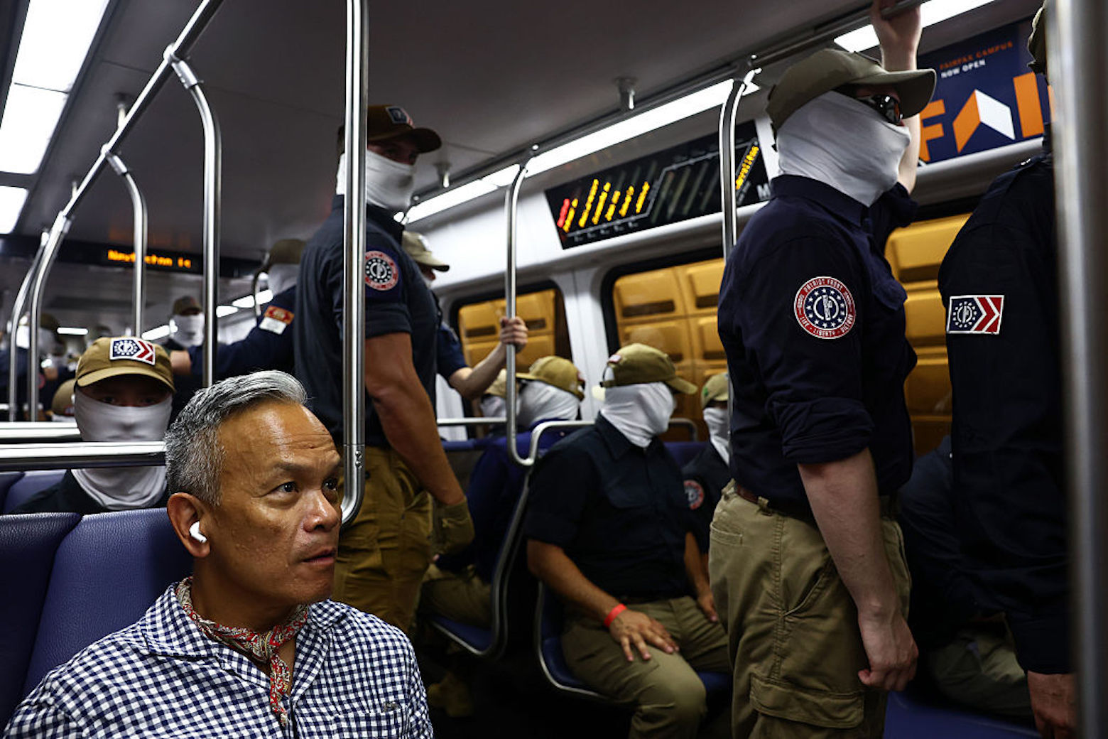 WASHINGTON, DC - JULY 04: Roswell Encina looks on as members of the white supremacist group Patriot Front ride the Washington Metro on July 04, 2026 in Washington, DC. Numerous events, activities, and fireworks are planned in celebration of America's 250th Anniversary.  (Photo by Finn Gomez/Getty Images)