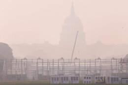 Smoke from massive wildfires in Canada and Minnesota engulf the D.C. skyline, reducing visibility and casting a colored haze over the U.S. Capitol Building