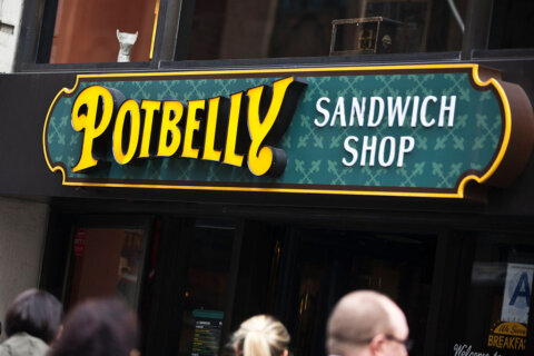 Pedestrians walk outside of a Potbelly Sandwich Shop