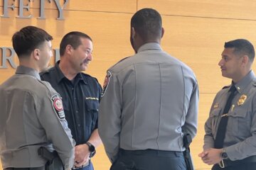police officers stand around and have a conversation