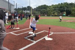 Kid hits ball off of T-ball stand