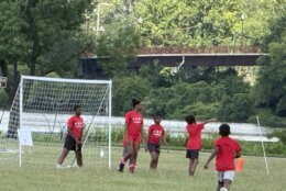 Campers stand in formation at the mouth of the net, penalty kick-style