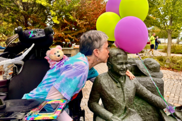 Mattie mom kissing his statue in the park named for him.