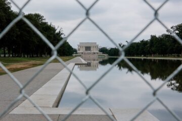 A fence surrounds the Lincoln Memorial Reflecting Pool in Washington, D.C., on July 8. Three more people have been criminally charged with destruction of property at the Lincoln Memorial Reflecting Pool.