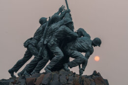 Smoke and haze from the Canadian wildfires shrouds the rising sun behind the U.S. Marine Corps War Memorial on July 17, 2026