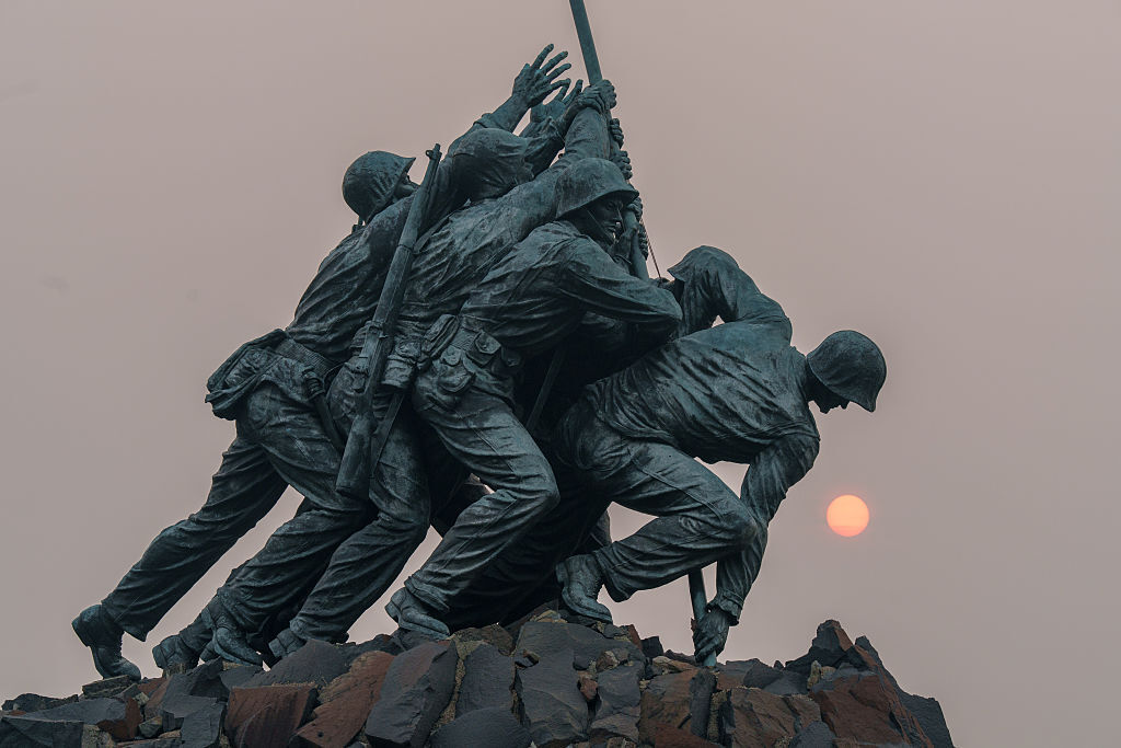Smoke and haze from the Canadian wildfires shrouds the rising sun behind the U.S. Marine Corps War Memorial on July 17, 2026