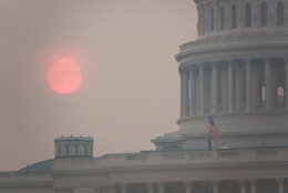 The sun rises behind the U.S. Capitol building during a summer heat wave as smoke from wildfires in Canada fills the air on July 17, 2026 in D.C.