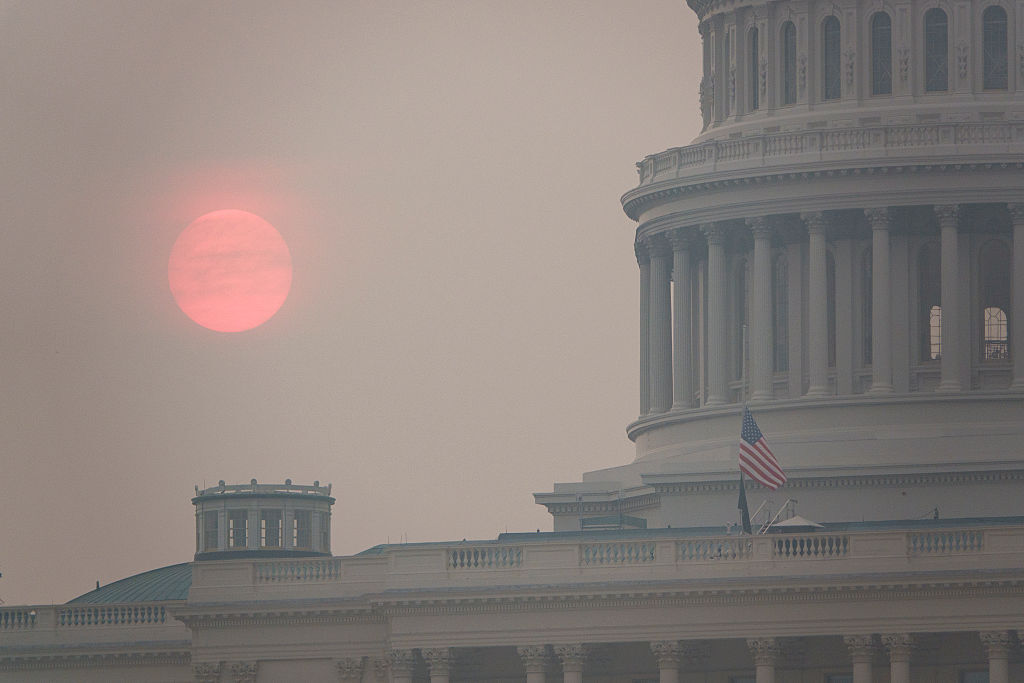 The sun rises behind the U.S. Capitol building during a summer heat wave as smoke from wildfires in Canada fills the air on July 17, 2026 in D.C.