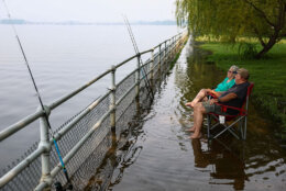 WASHINGTON, DC - JULY 17: Nancy and Thomas Rinker relax while fishing along the Potomac River as smoke from massive wildfires in Canada and Minnesota engulf the Washington, D.C. skyline, reducing visibility and casting a colored haze near the Ronald Reagan Washington National Airport on July 17, 2026 in Washington, DC. Authorities are continuing to monitor for unsafe conditions as air quality alerts are in effect across a vast portion of the United States. (Photo by Finn Gomez/Getty Images)