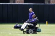 Baltimore Ravens senior advisor to player engagement O.J. Brigance, front, watches an NFL football training camp practice in Owings Mills, Md., Tuesday, Aug. 8, 2017. (AP Photo/Patrick Semansky)